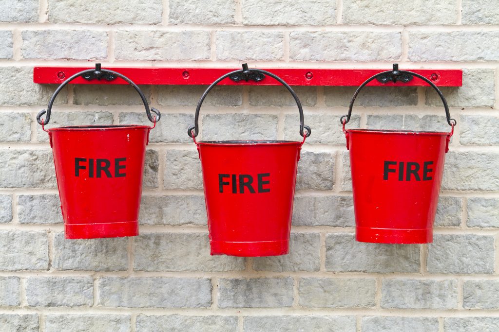 Three fire buckets hanging on a wall